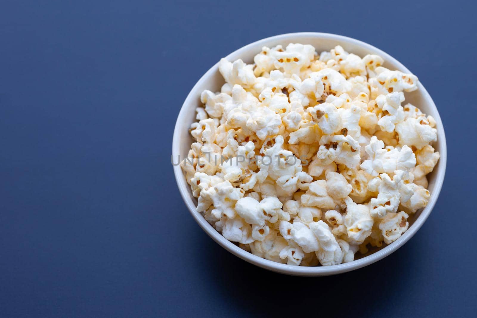 Popcorn on dark background. Copy space