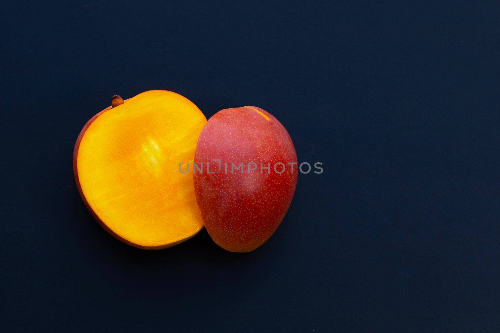 Tropical fruit, Mango on dark background.