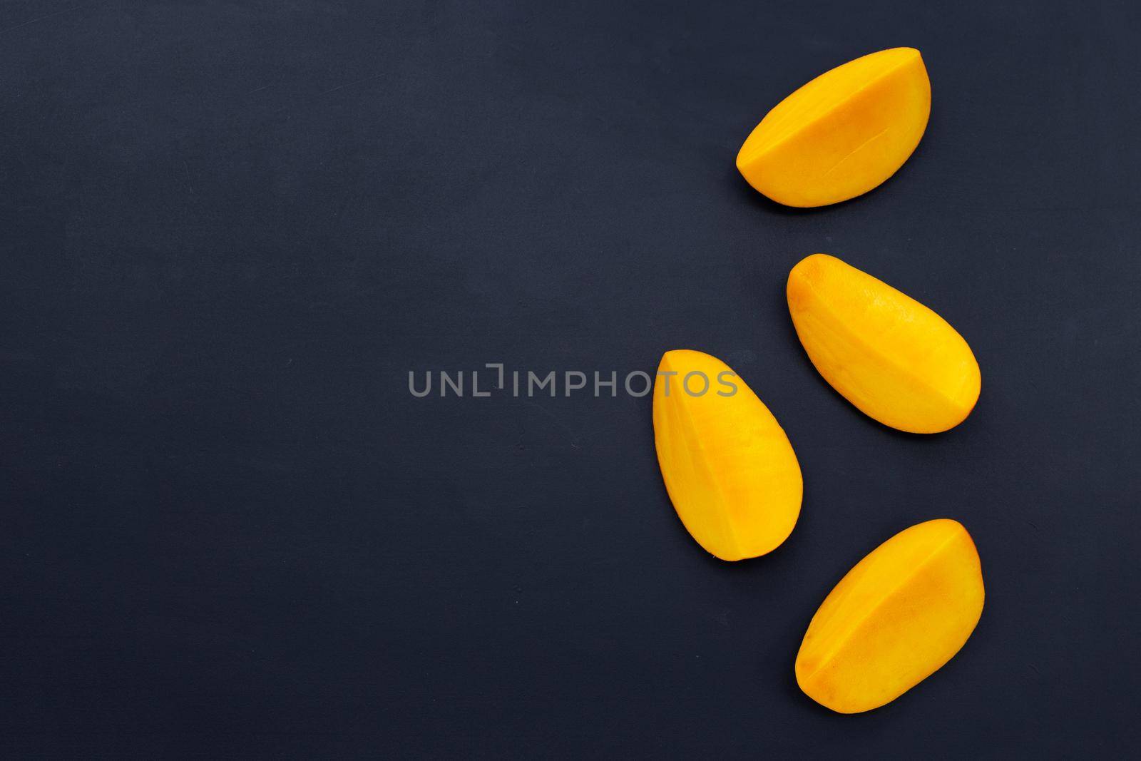 Tropical fruit, Mango  on dark background.
