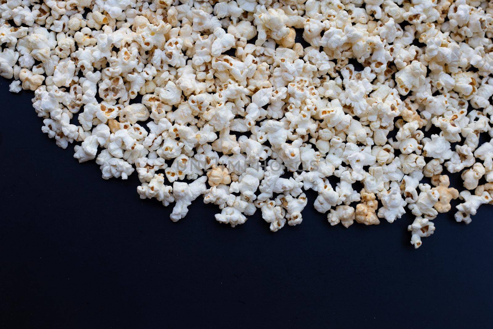 Popcorn on dark background. Copy space by Bowonpat