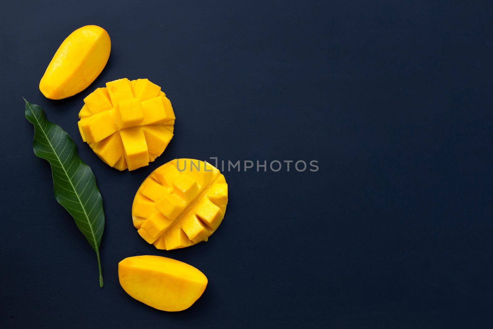 Tropical fruit, Mango  on dark background.