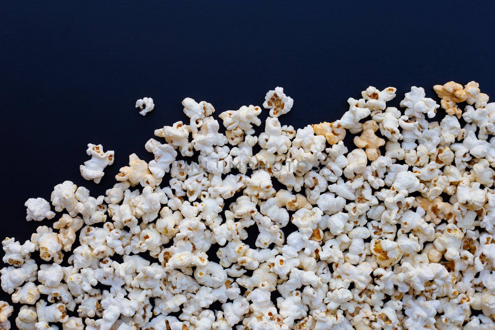 Popcorn on dark background. Copy space by Bowonpat