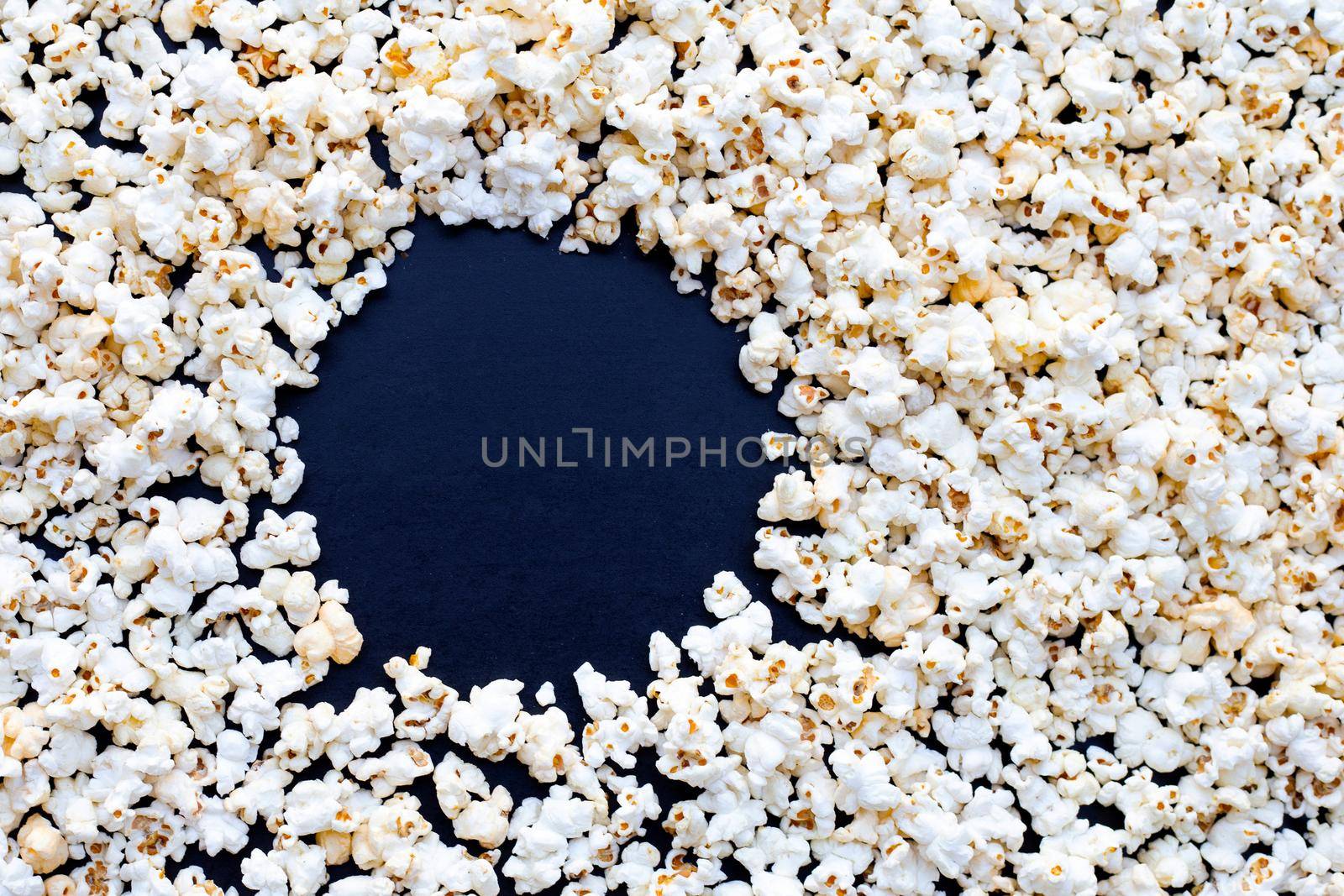 Popcorn on dark background. Copy space by Bowonpat