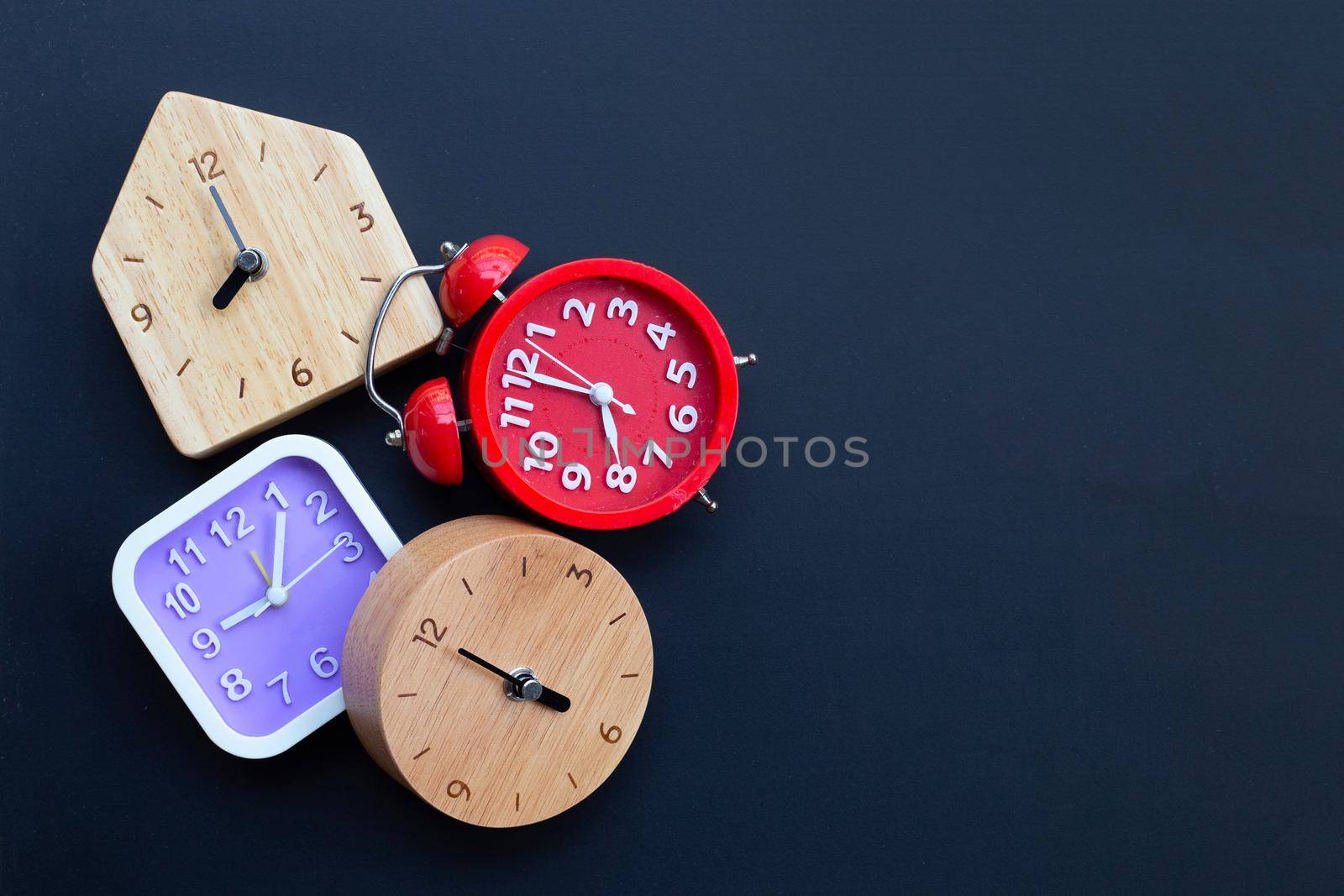 Clocks on dark background. Copy space