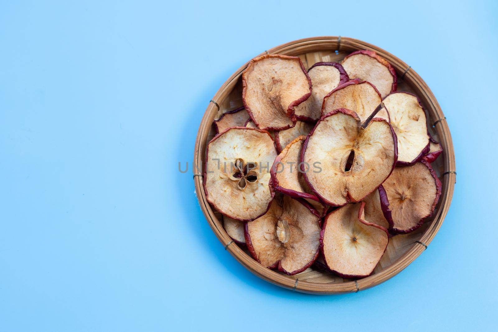 Dried apple slices on blue background