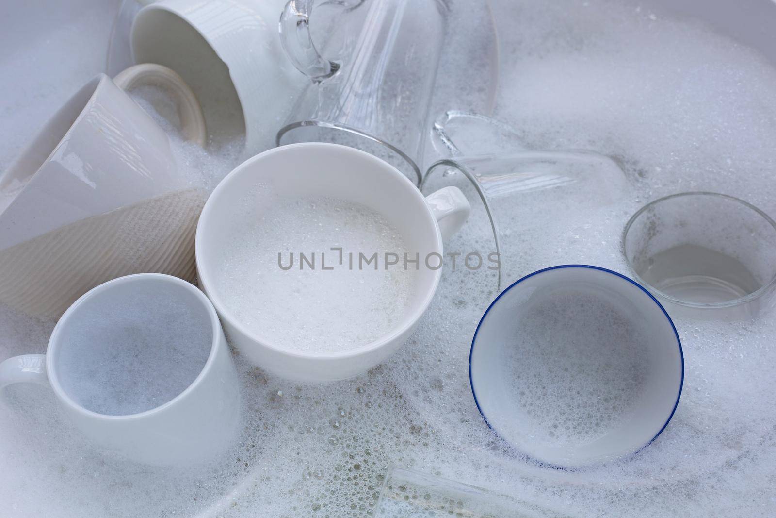 Washing used drinking glasses and cups by Bowonpat