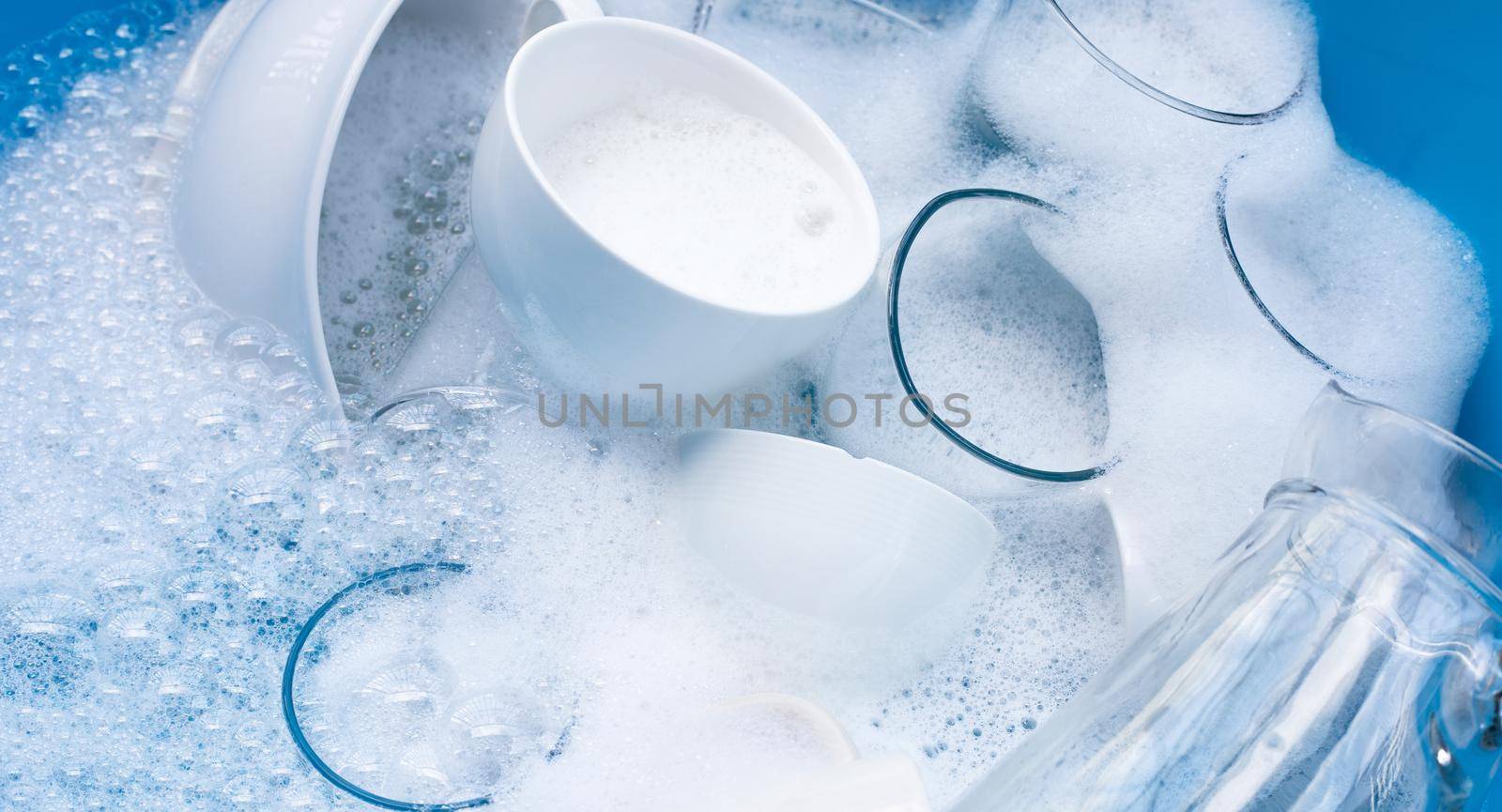 Washing used drinking glasses and cups by Bowonpat