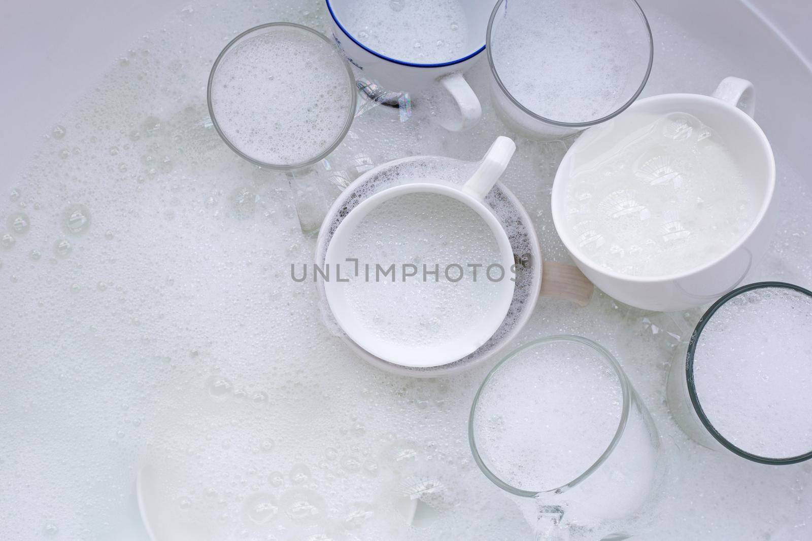 Washing an used drinking glasses and cups by Bowonpat