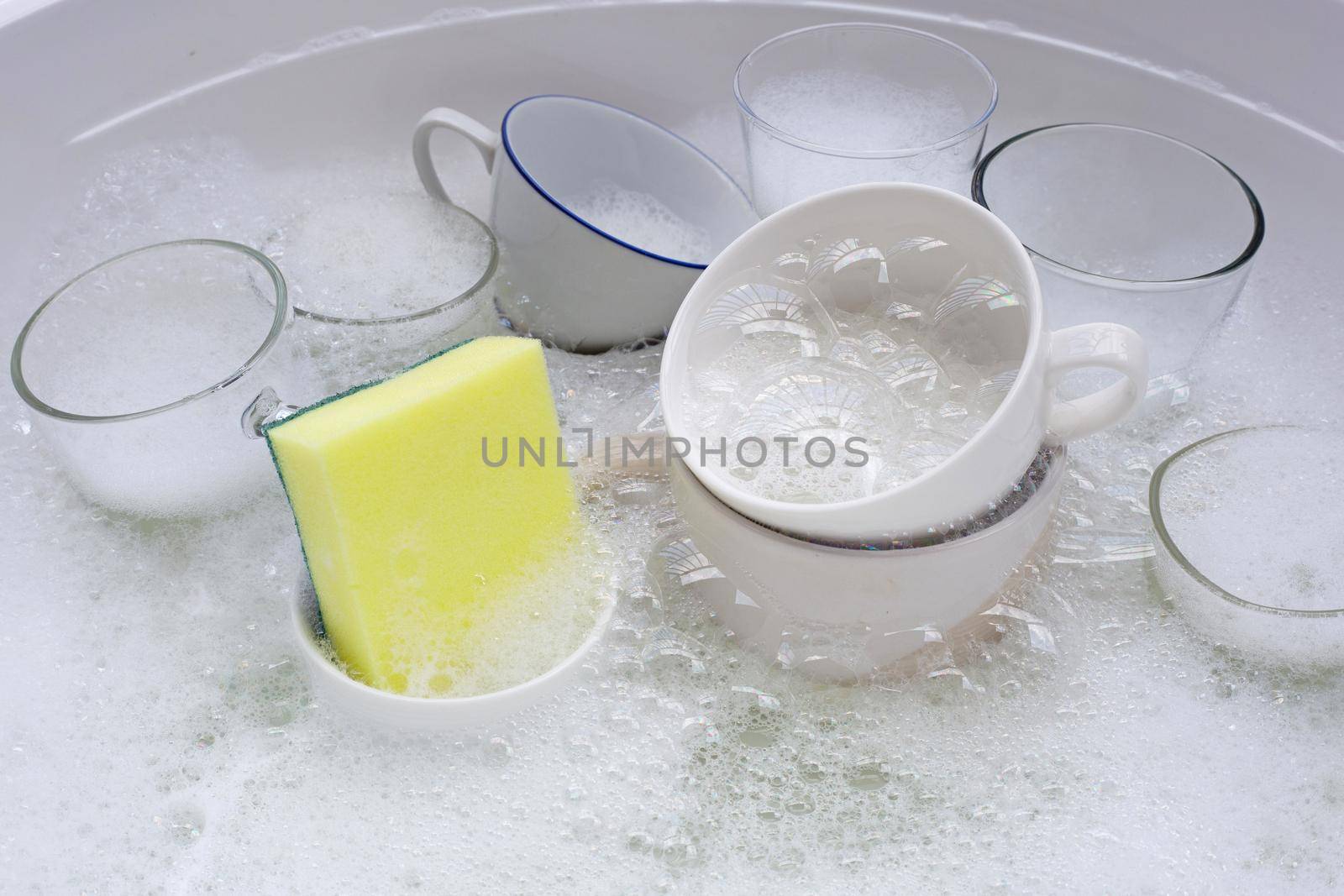 Washing an used drinking glasses and cups by Bowonpat