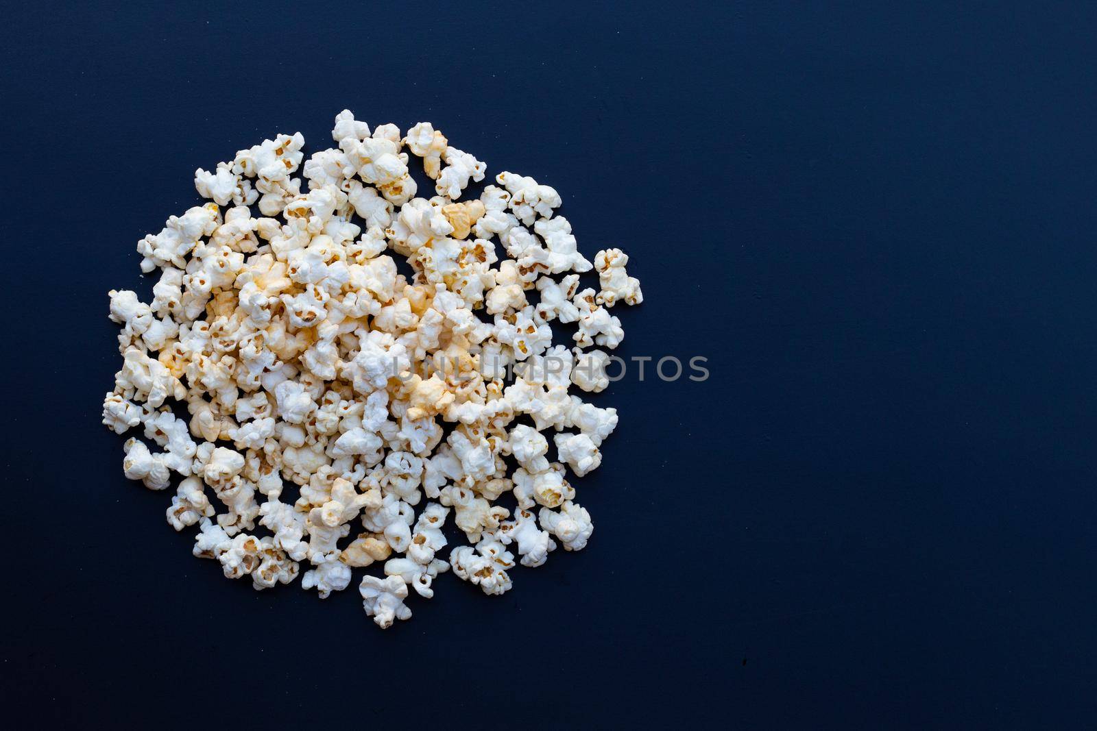 Popcorn on dark background. Copy space by Bowonpat