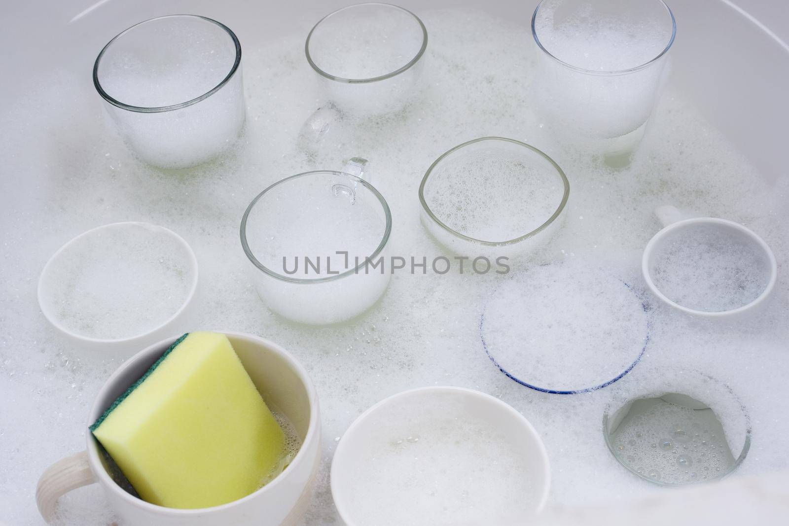 Washing used drinking glasses and cups by Bowonpat