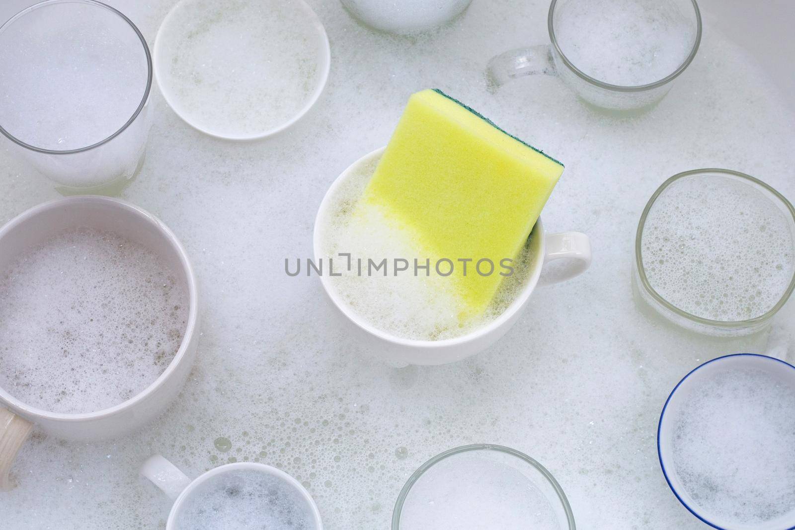 Washing an used drinking glasses and cups by Bowonpat