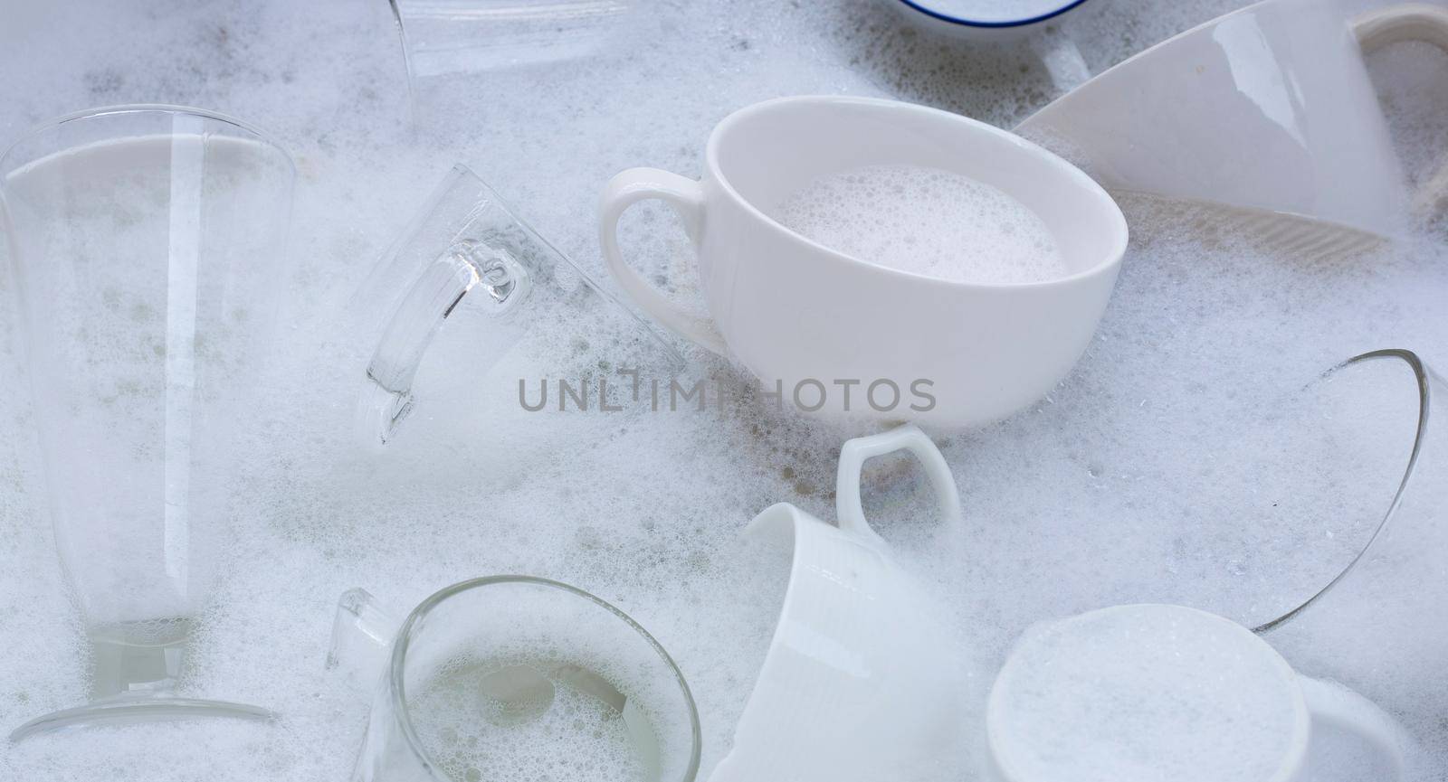 Washing used drinking glasses and cups by Bowonpat
