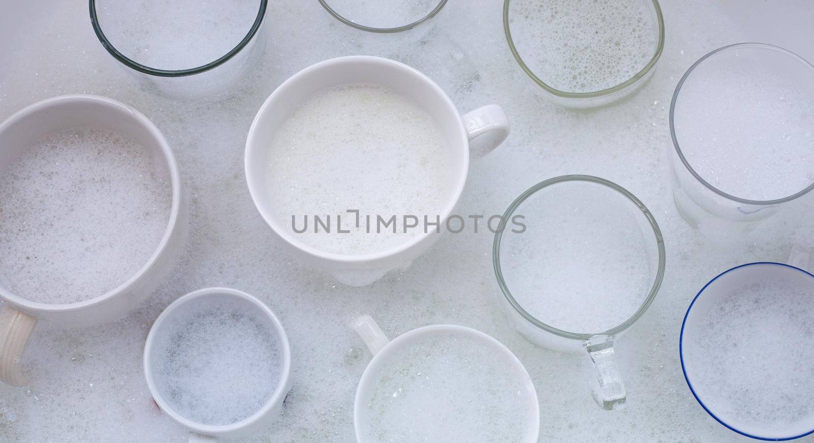 Washing used drinking glasses and cups by Bowonpat
