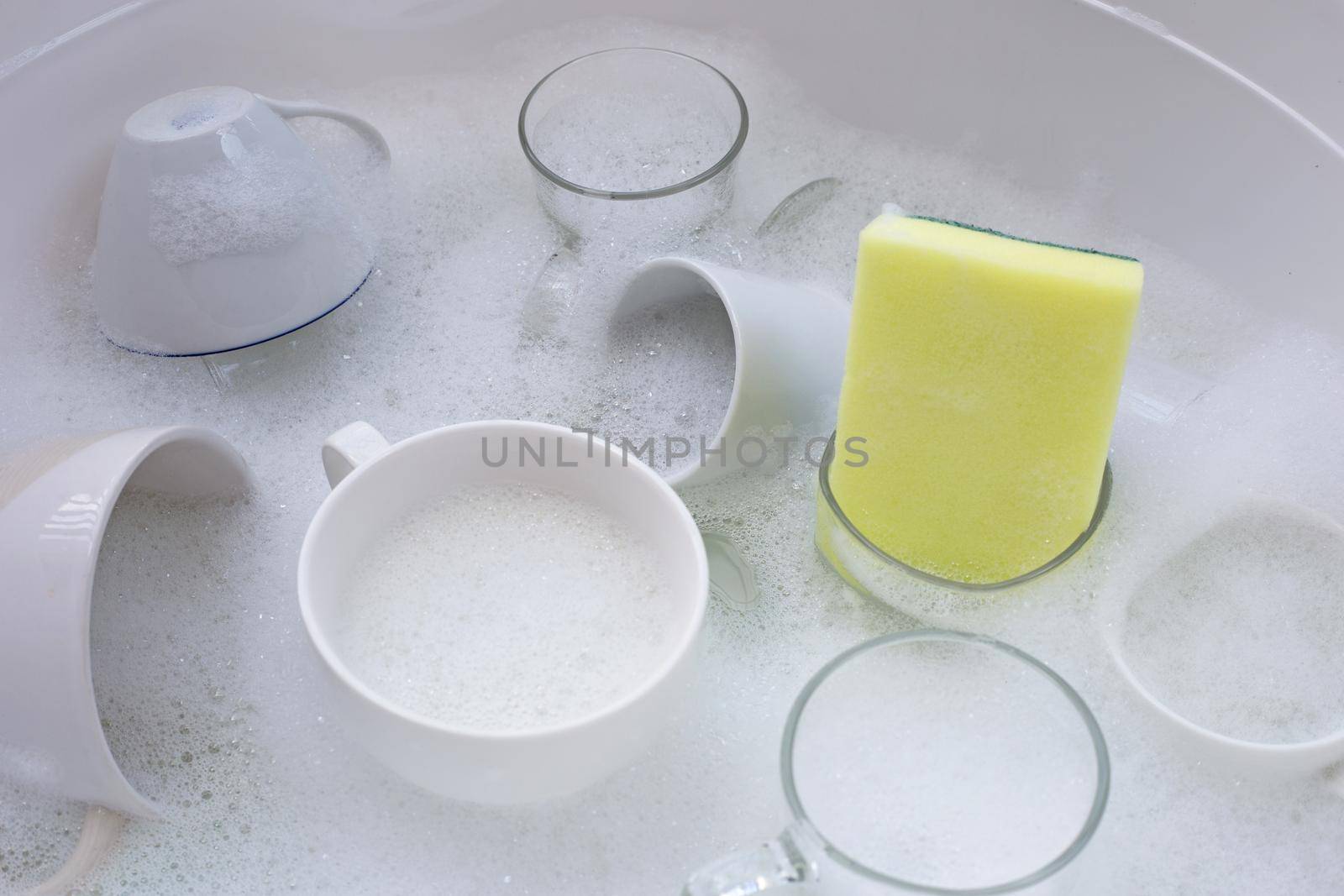 Washing used drinking glasses and cups by Bowonpat