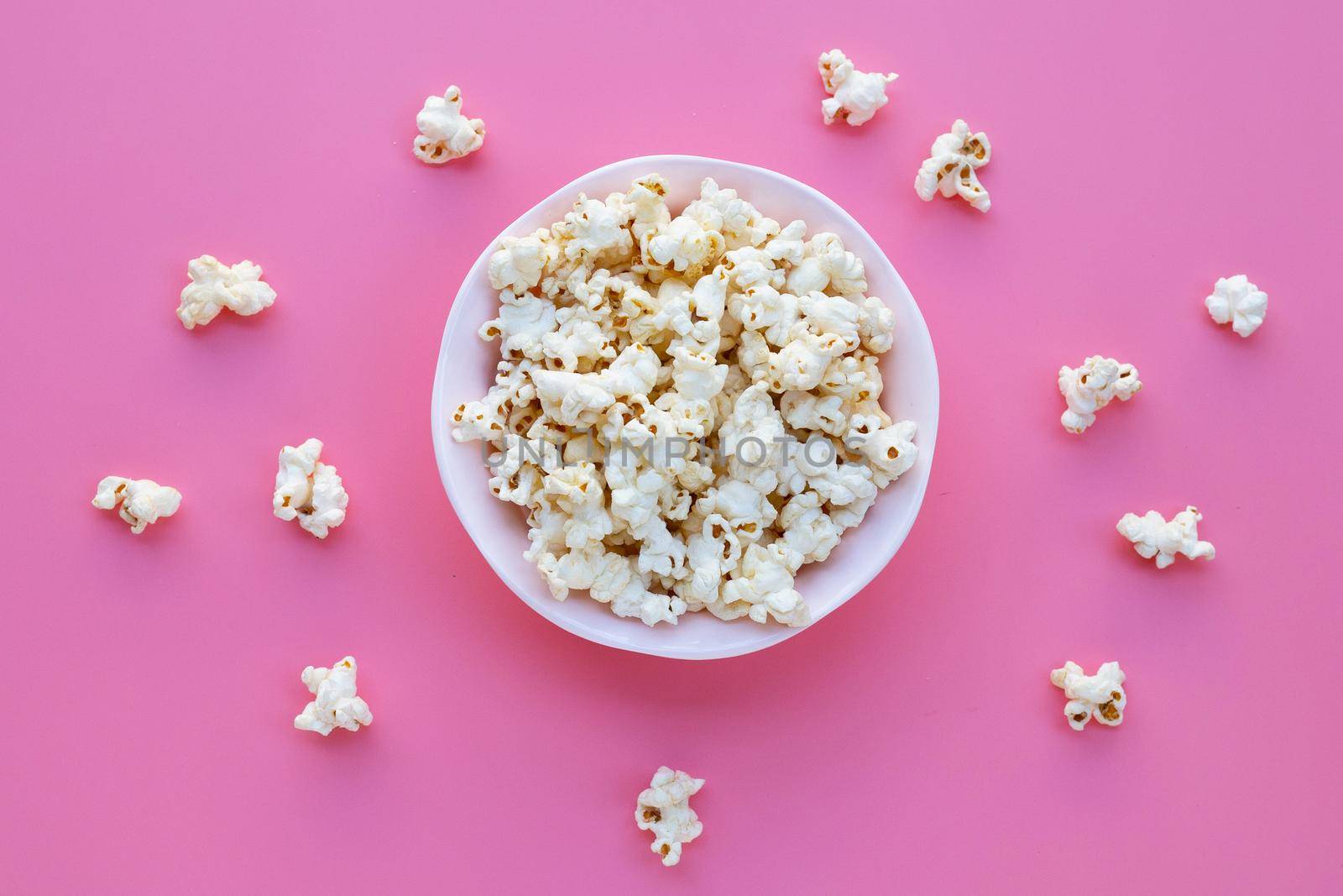 Popcorn on pink background. Copy space by Bowonpat