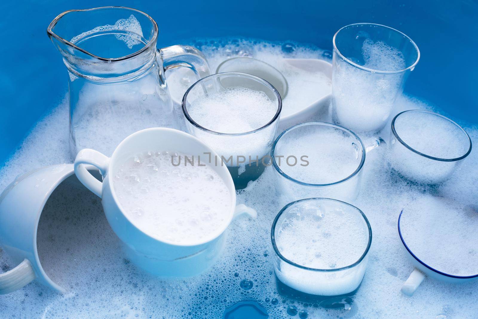 Washing used drinking glasses and cups by Bowonpat