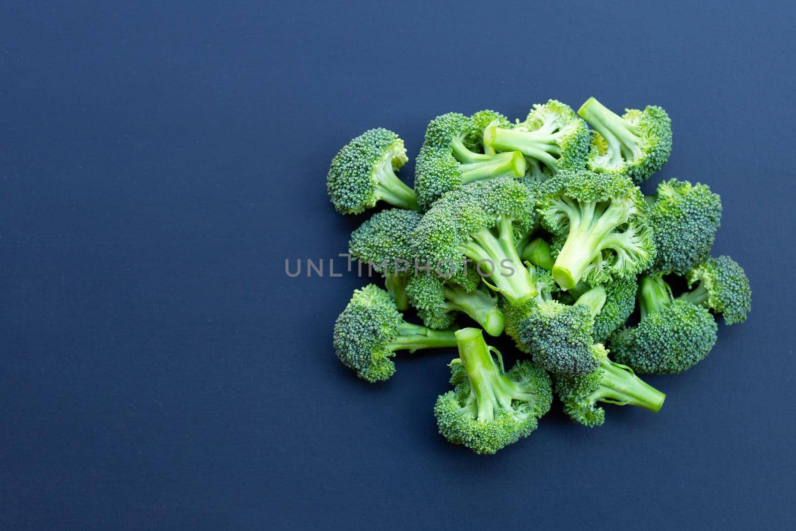 Fresh green broccoli on dark background. by Bowonpat