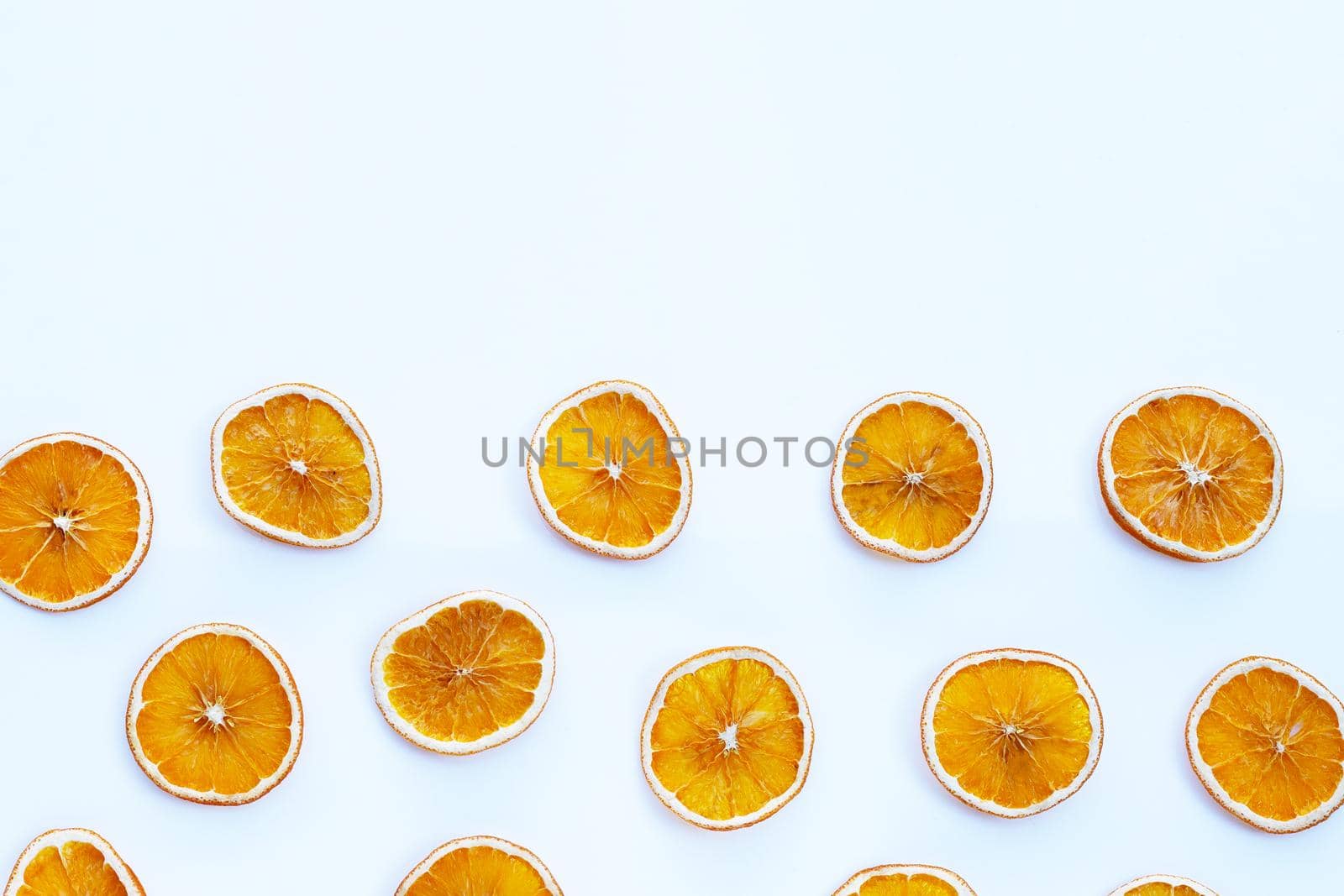 Dried orange slices on white background.