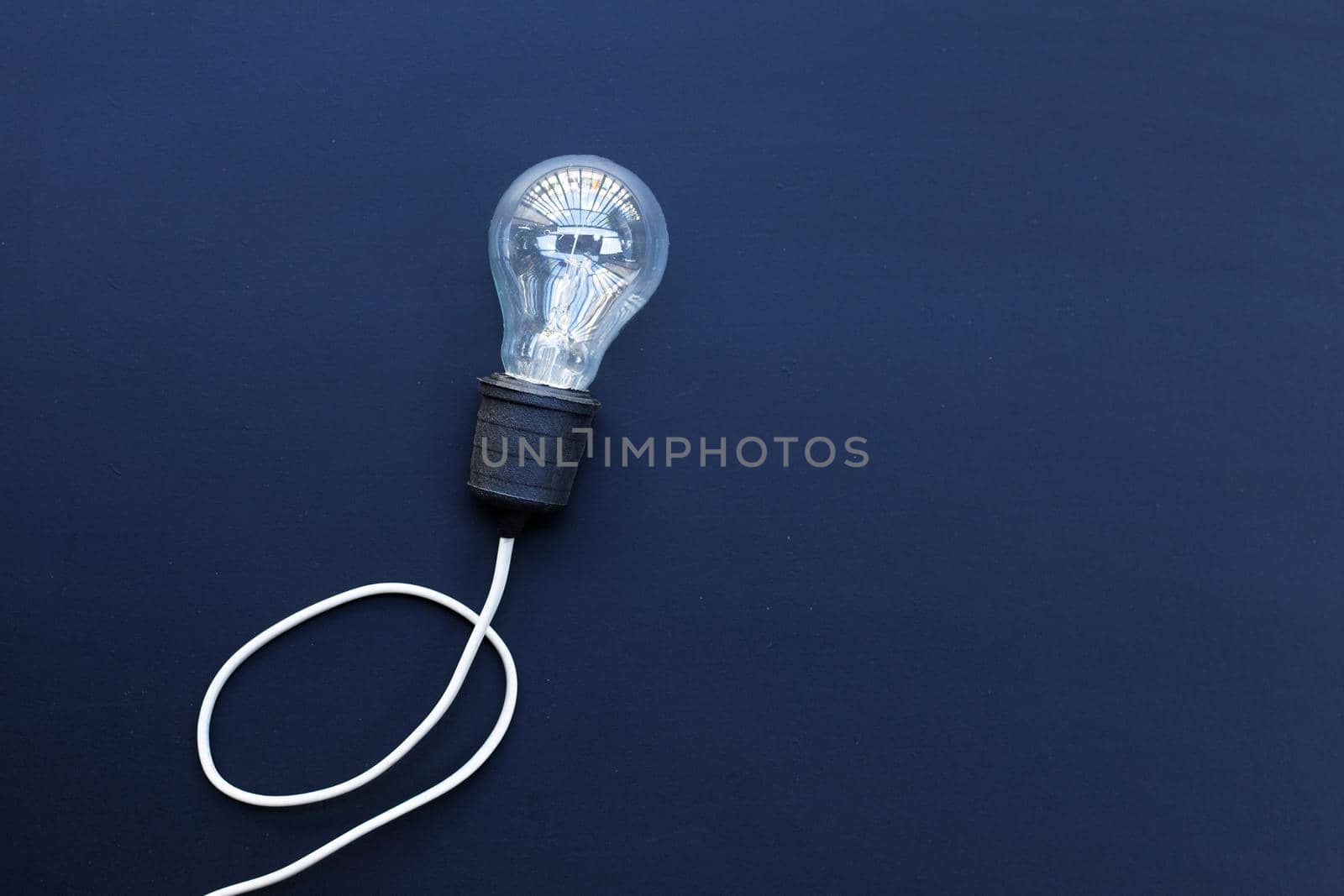 Light bulb on dark background. Ideas and creative thinking concept. Top view by Bowonpat