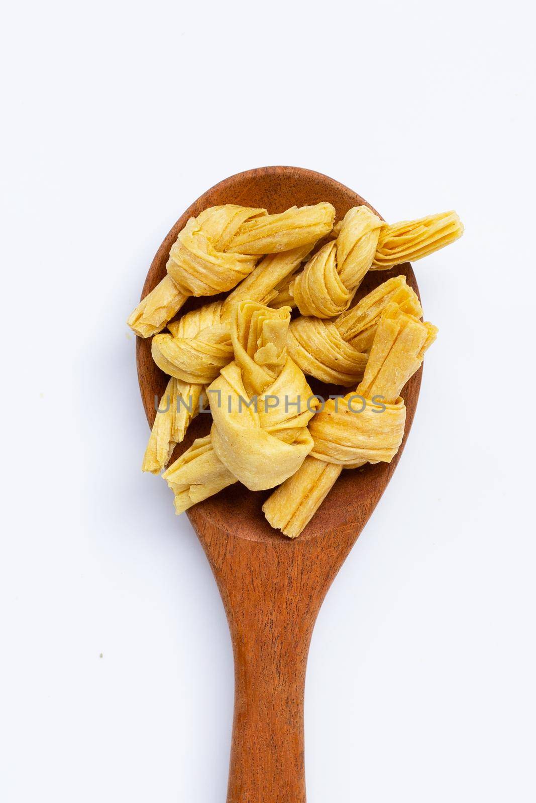 Dried bean curd knot on white background.