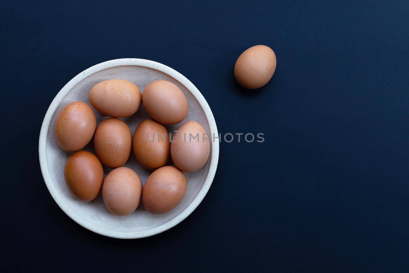 Eggs on dark background. Copy space by Bowonpat