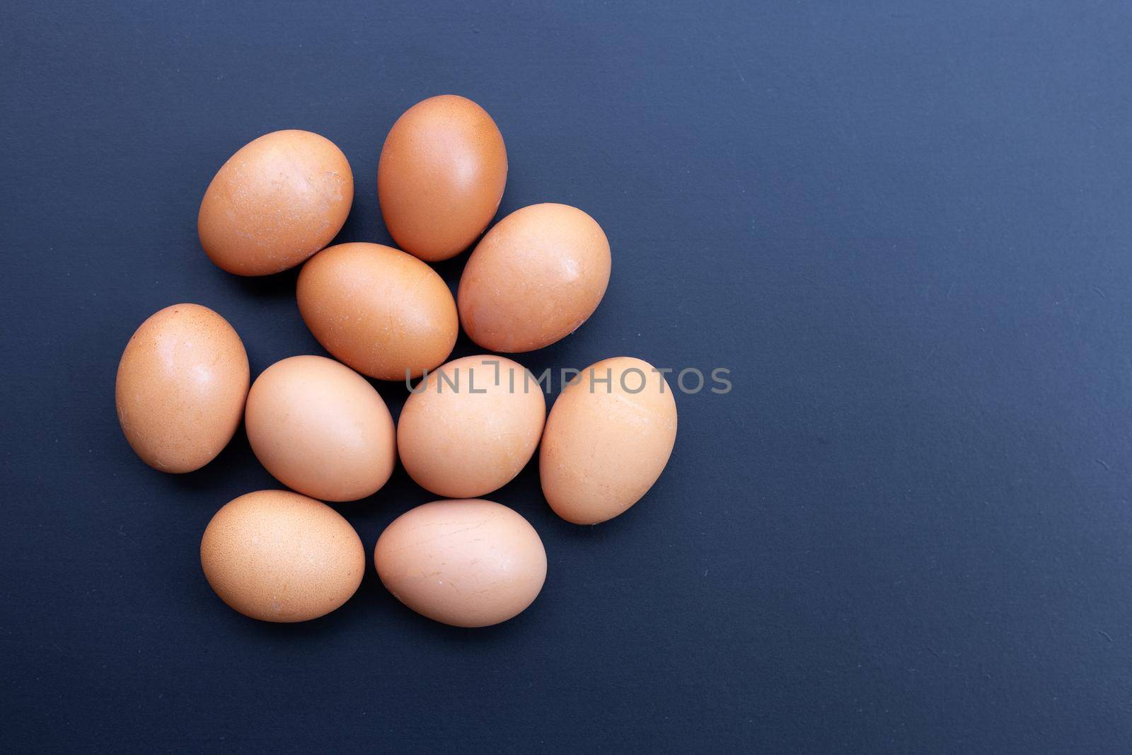 Eggs on dark background. Copy space by Bowonpat