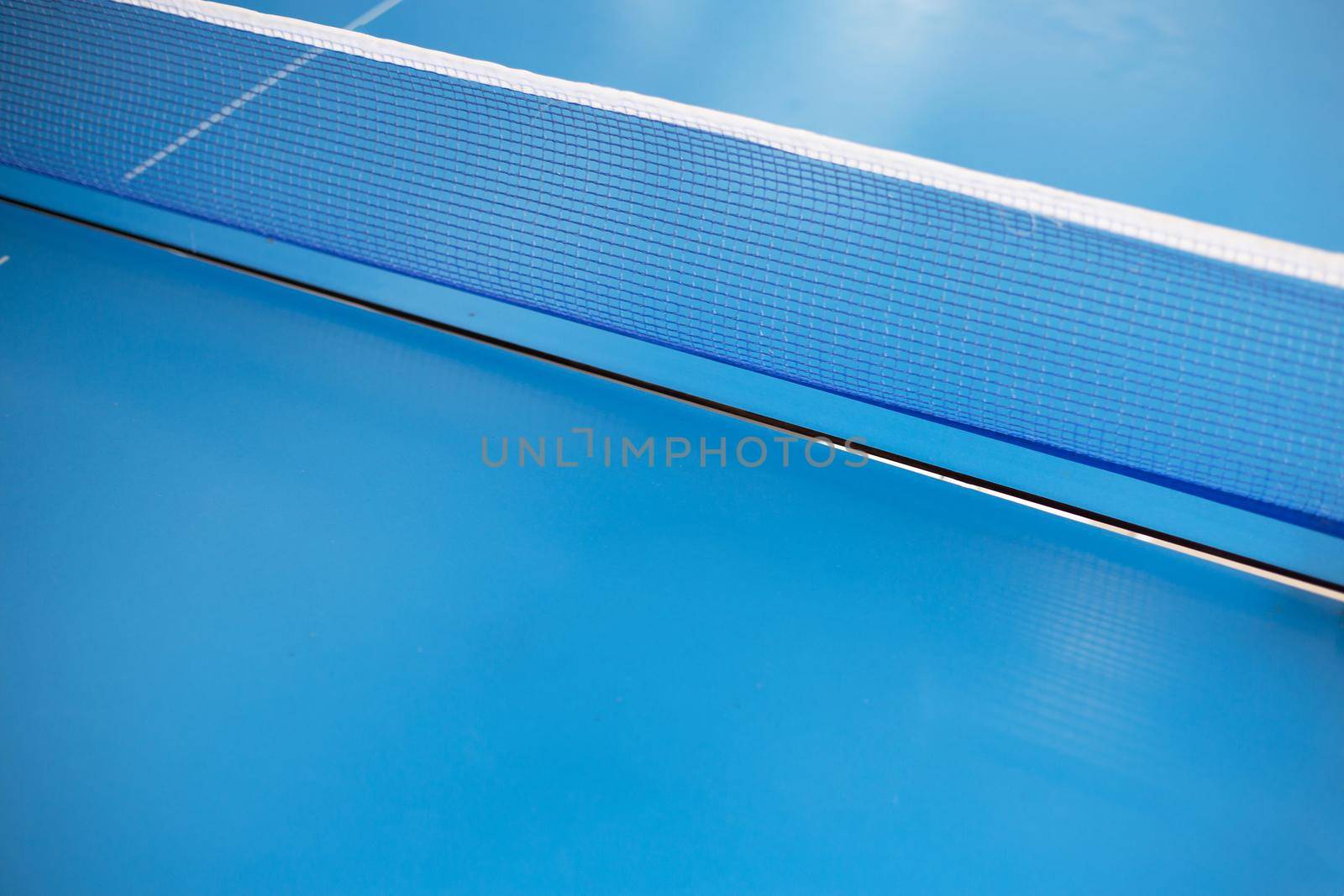 Net of table tennis ping pong on blue background.