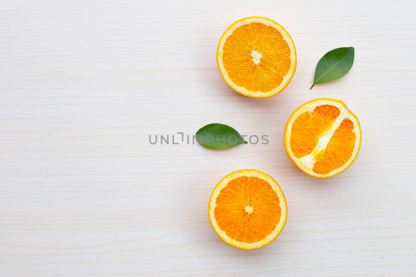 Sliced oranges on table background. High vitamin C, Juicy and sweet. by Bowonpat