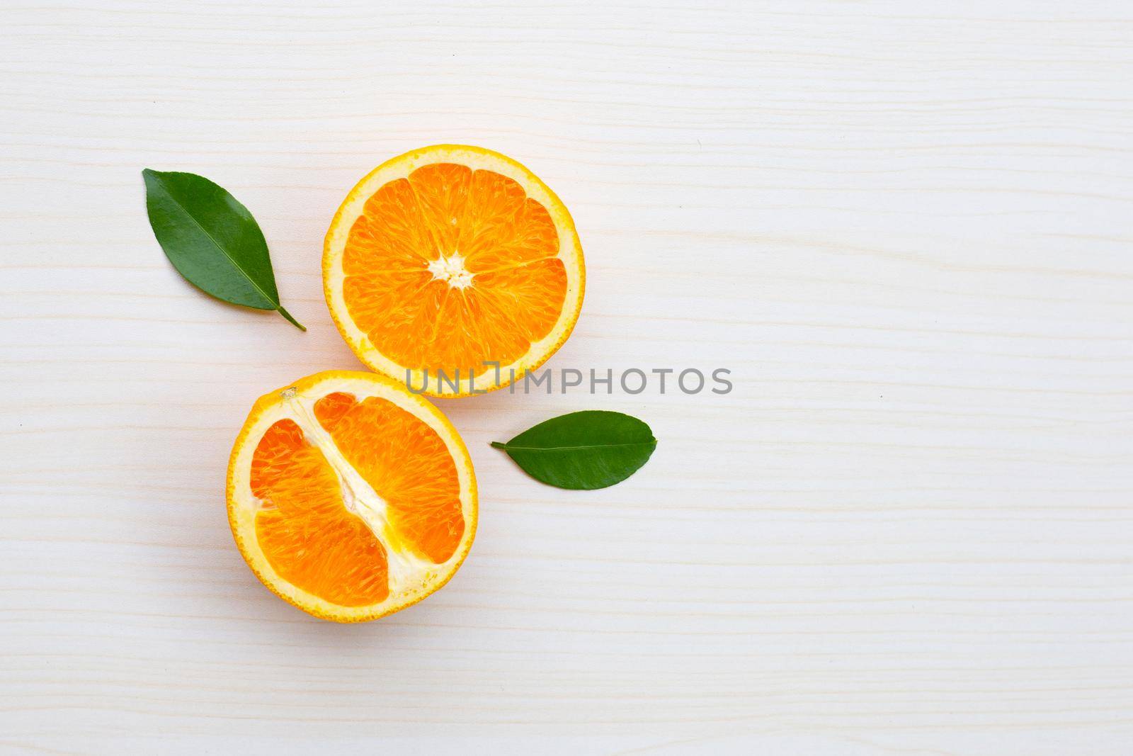 Sliced oranges on table background. High vitamin C, Juicy and sweet. by Bowonpat