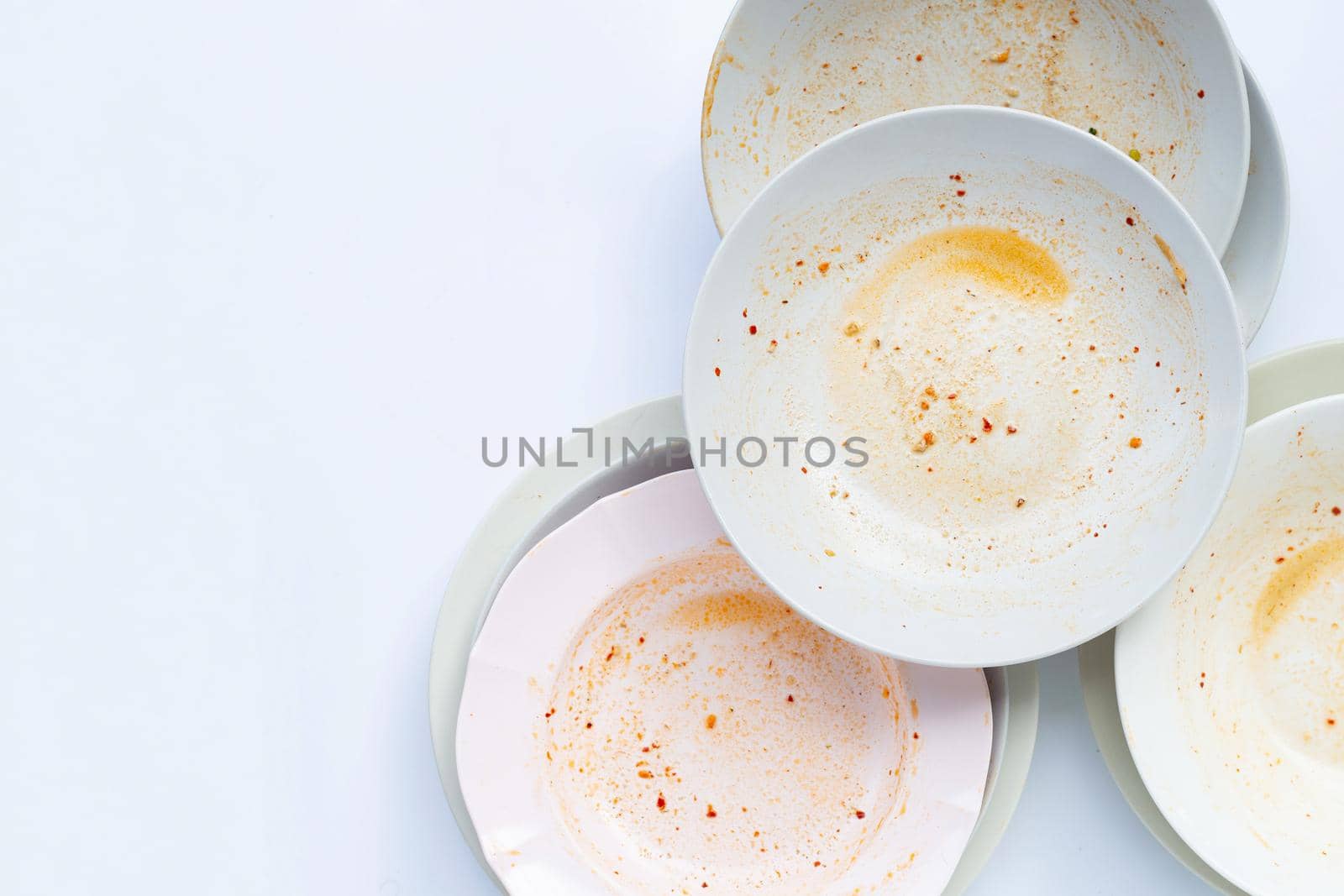 Dirty dishes on white background. by Bowonpat
