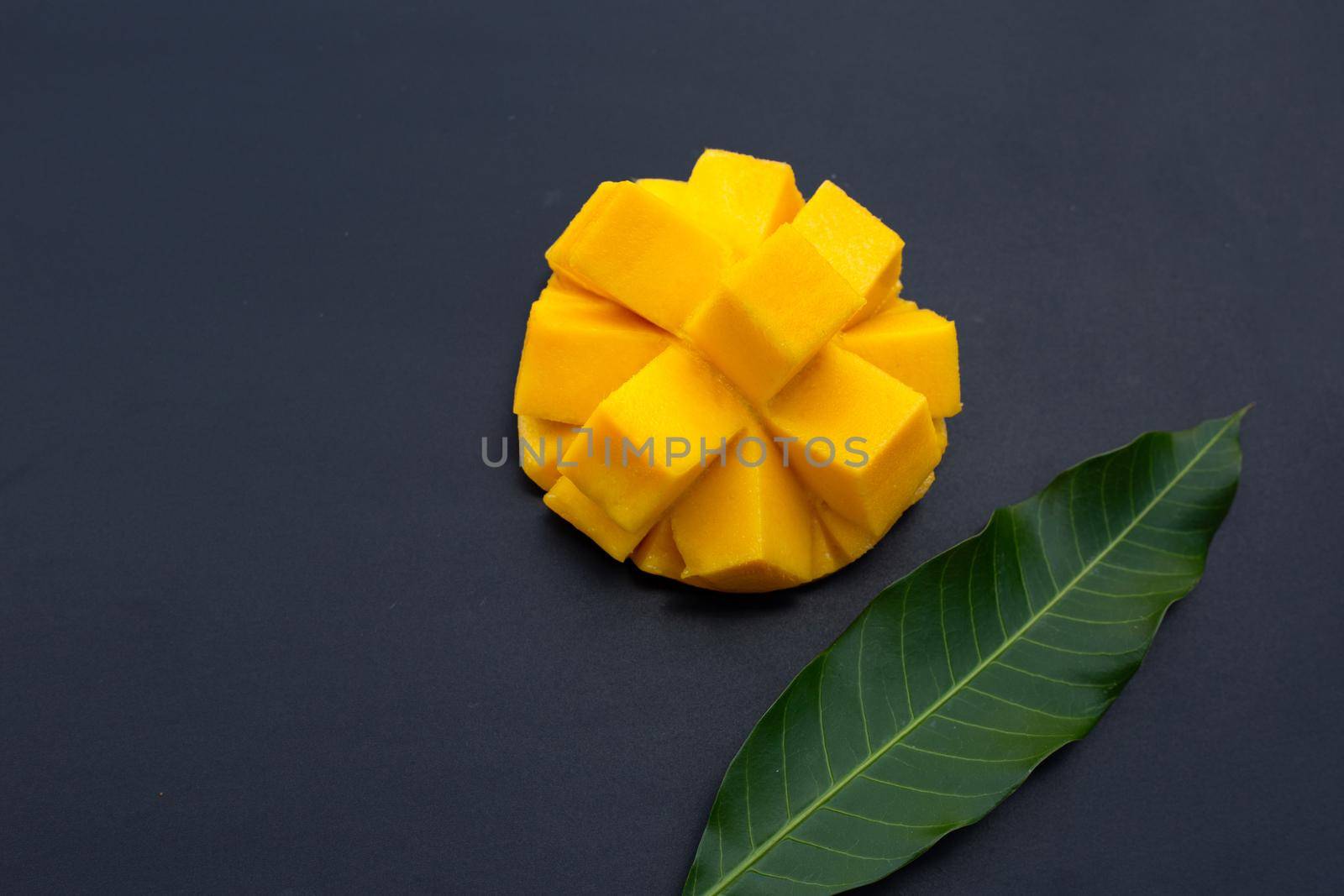 Tropical fruit, Mango on dark background.