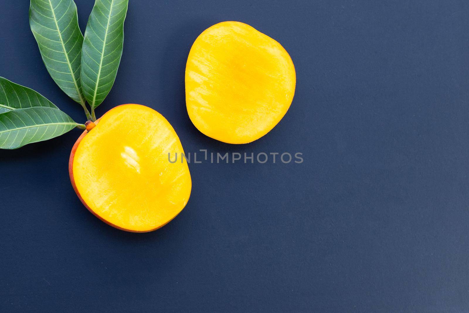 Tropical fruit, Mango  on dark background.