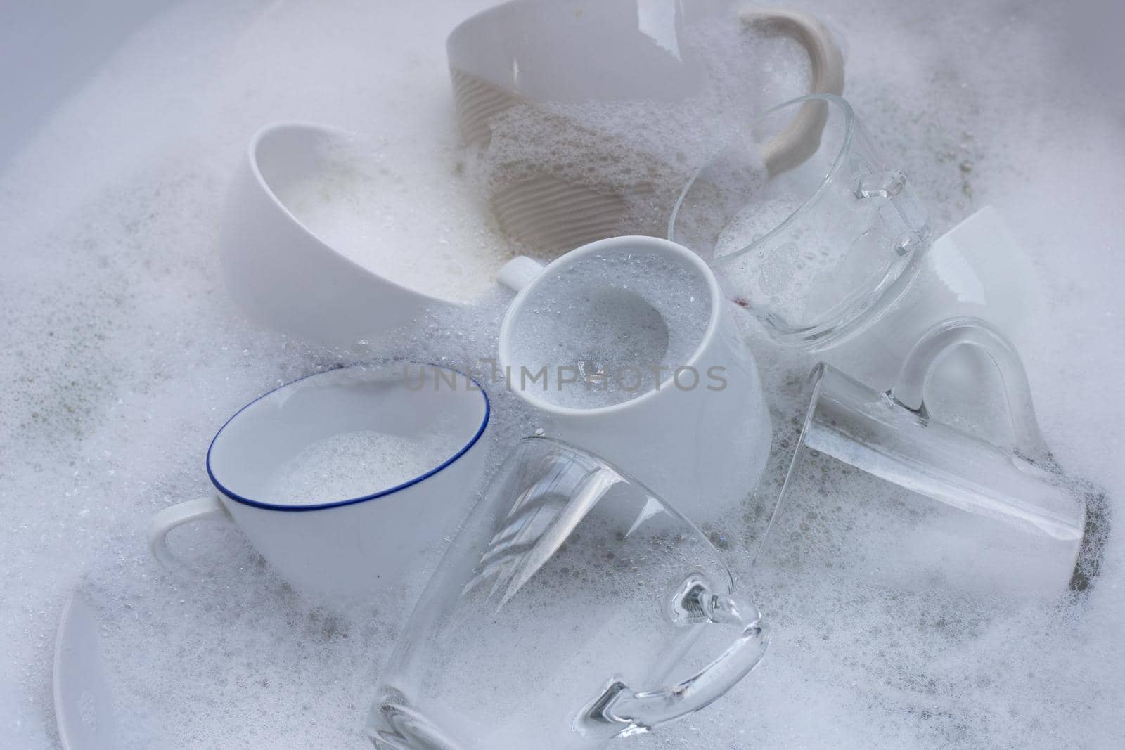 Washing used drinking glasses and cups by Bowonpat