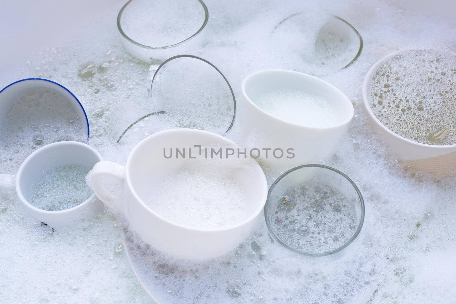 Washing used drinking glasses and cups by Bowonpat