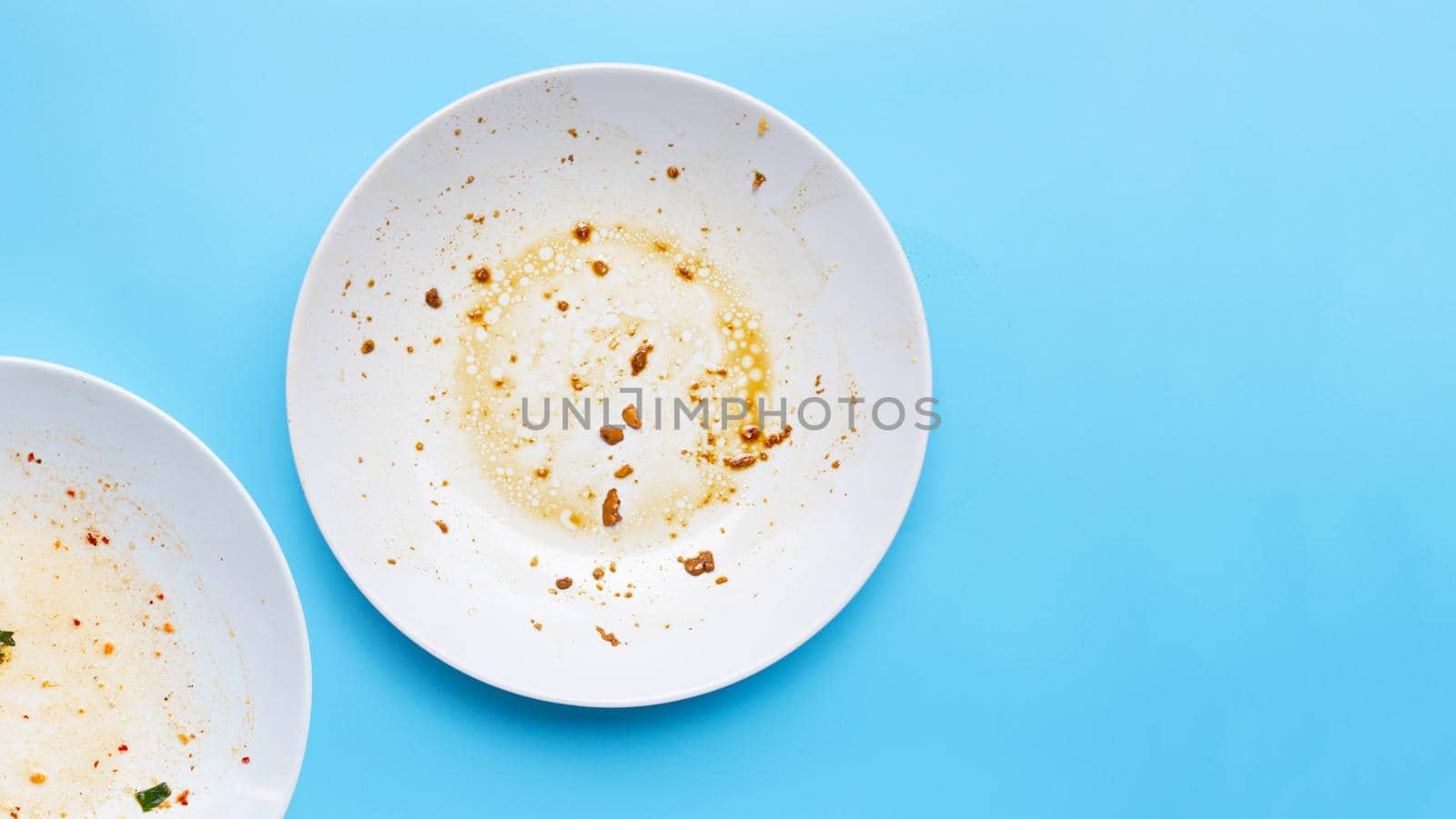 Dirty dishes on blue background.