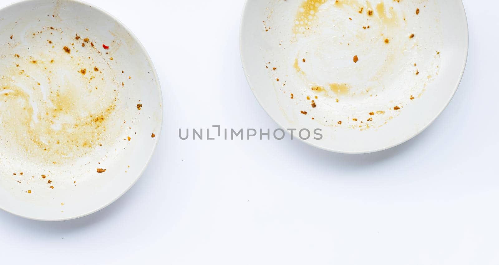 Dirty dishes on white background. by Bowonpat