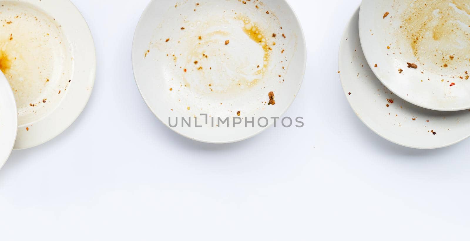 Dirty dishes on white background. by Bowonpat