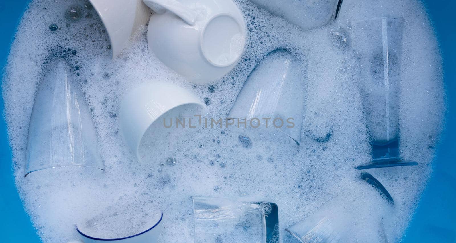 Washing used drinking glasses and cups by Bowonpat