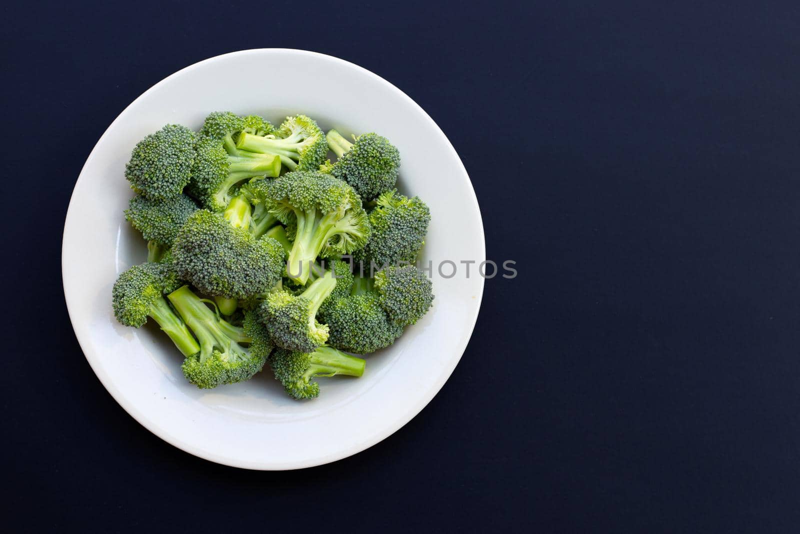 Fresh green broccoli on dark background. by Bowonpat