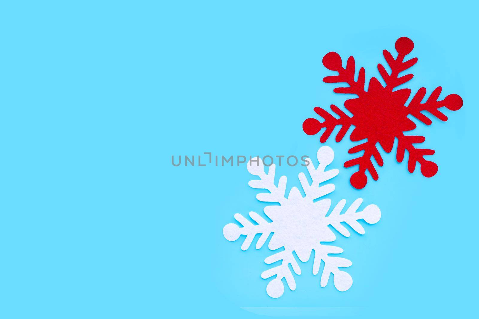 Christmas snowflake on blue background. by Bowonpat