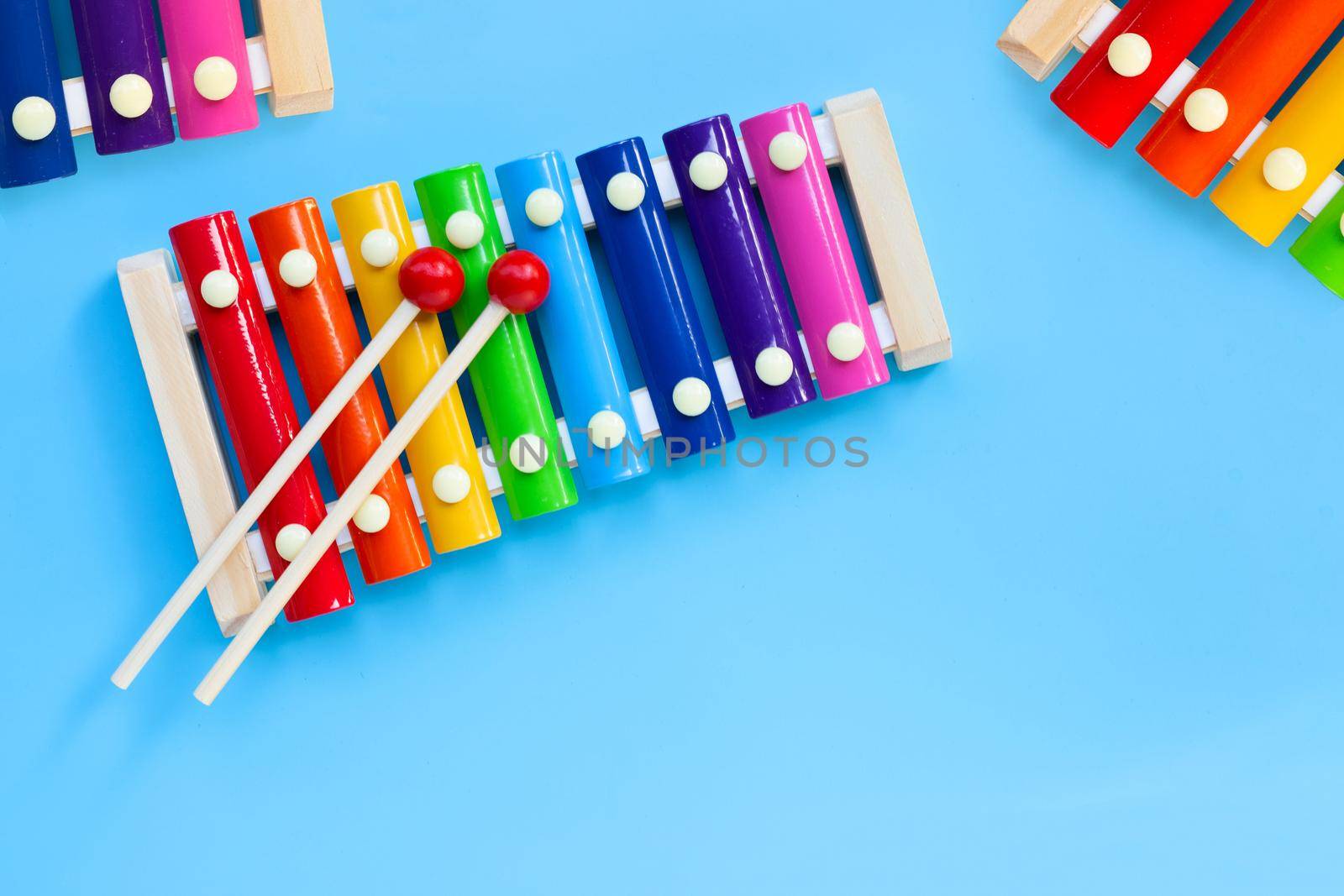 Colorful xylophone on blue background. by Bowonpat