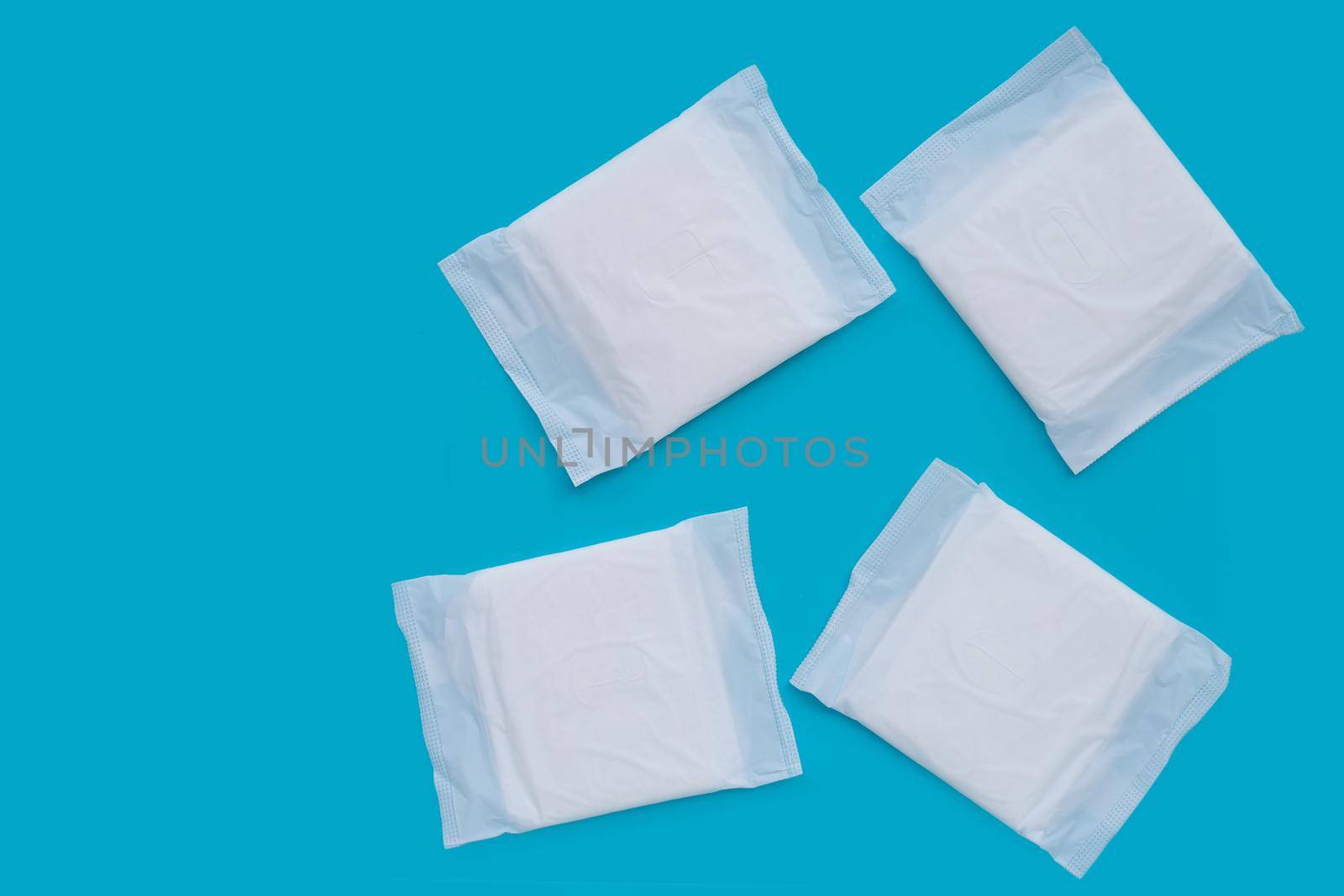 White sanitary pads on blue background. by Bowonpat