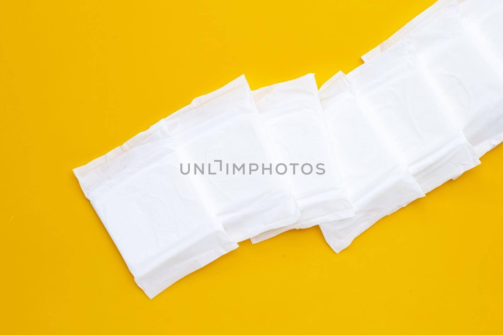 White sanitary pads on yellow background. by Bowonpat