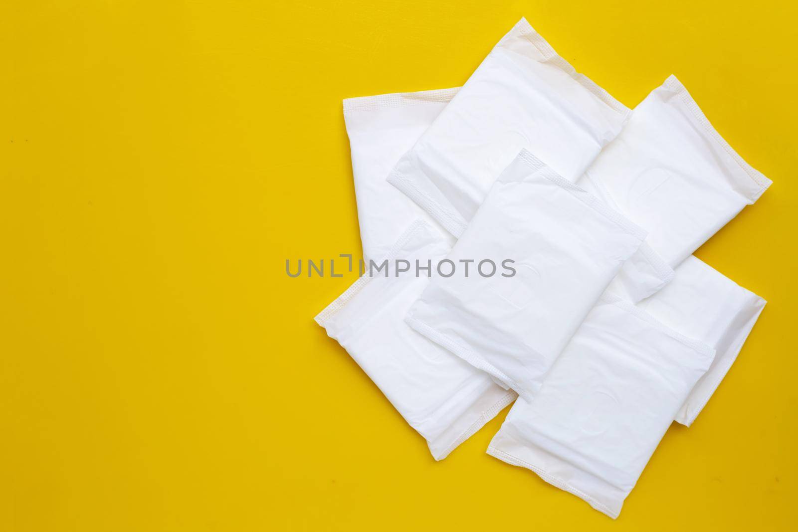 White sanitary pads on yellow background. by Bowonpat