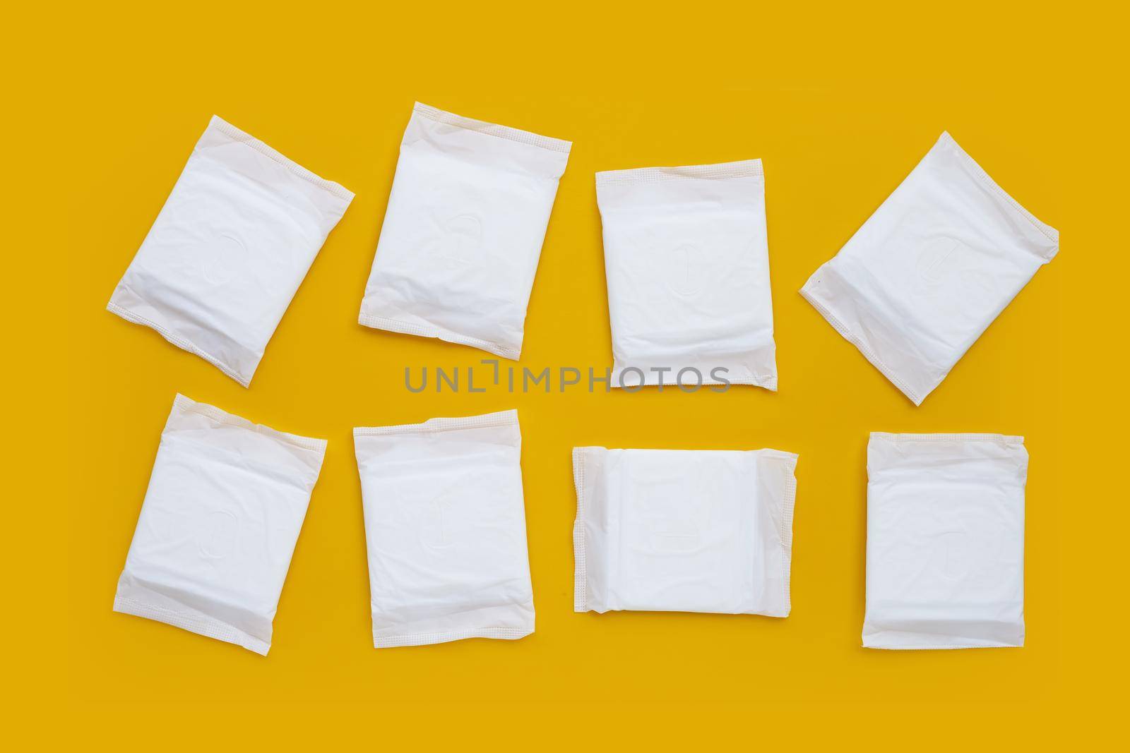 White sanitary pads on yellow background.