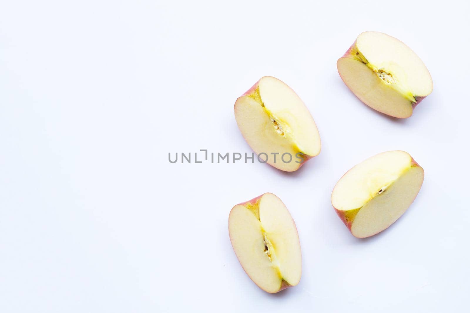 Ripe apple slices on white background.