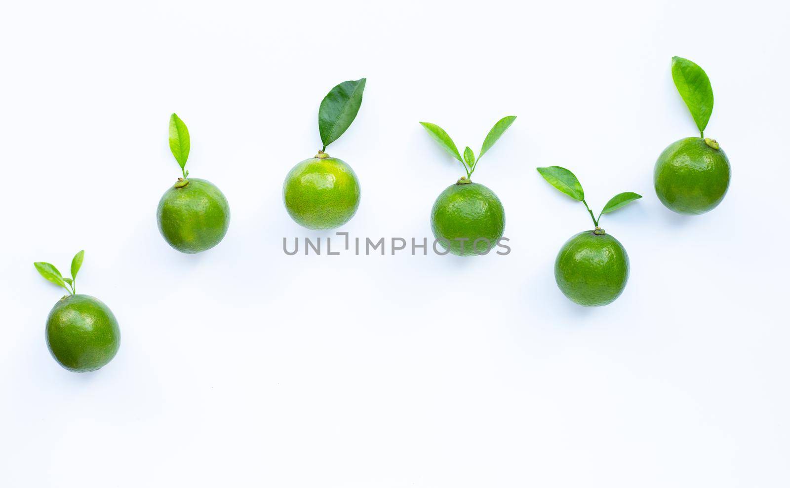 Limes with leaves isolated on white background.