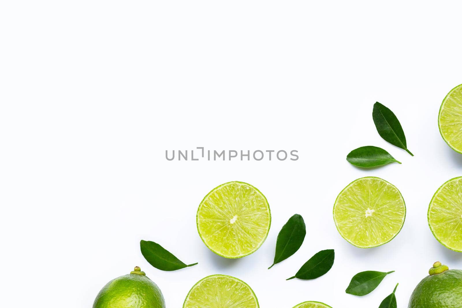 Limes with leaves isolated on white background.