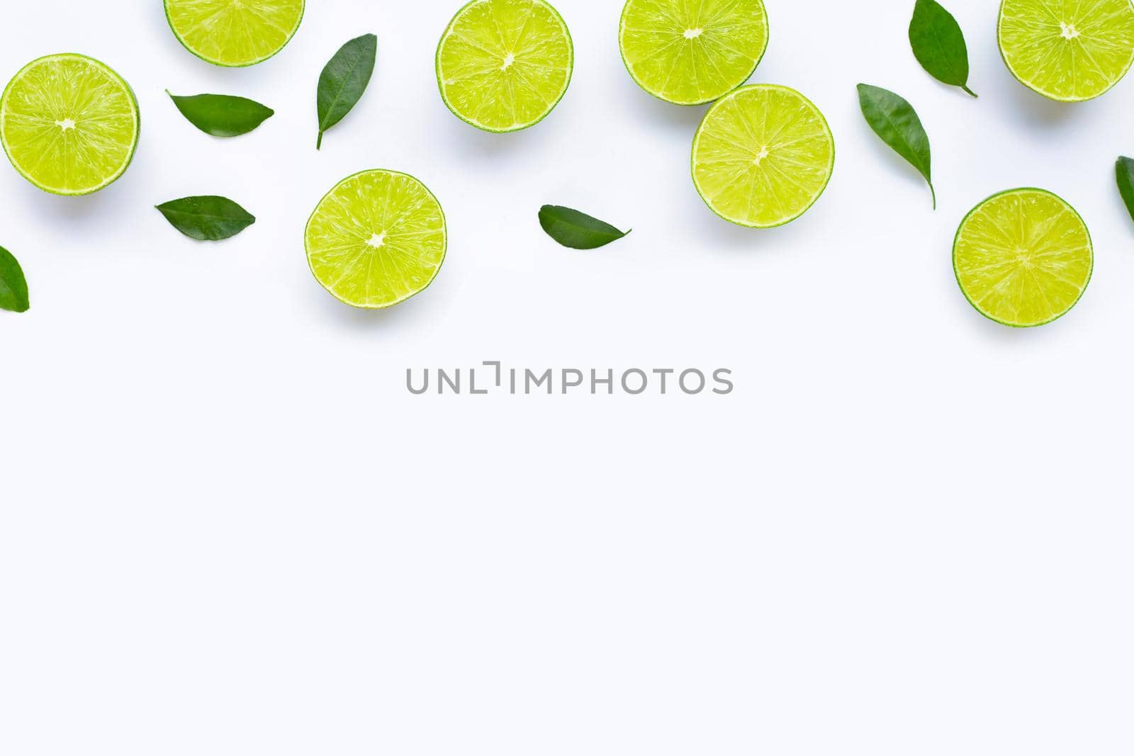 Limes with leaves isolated on white background.